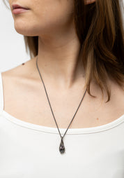 Oxidized Sterling Hand Holding Triangle Amethyst Necklace - December Thieves